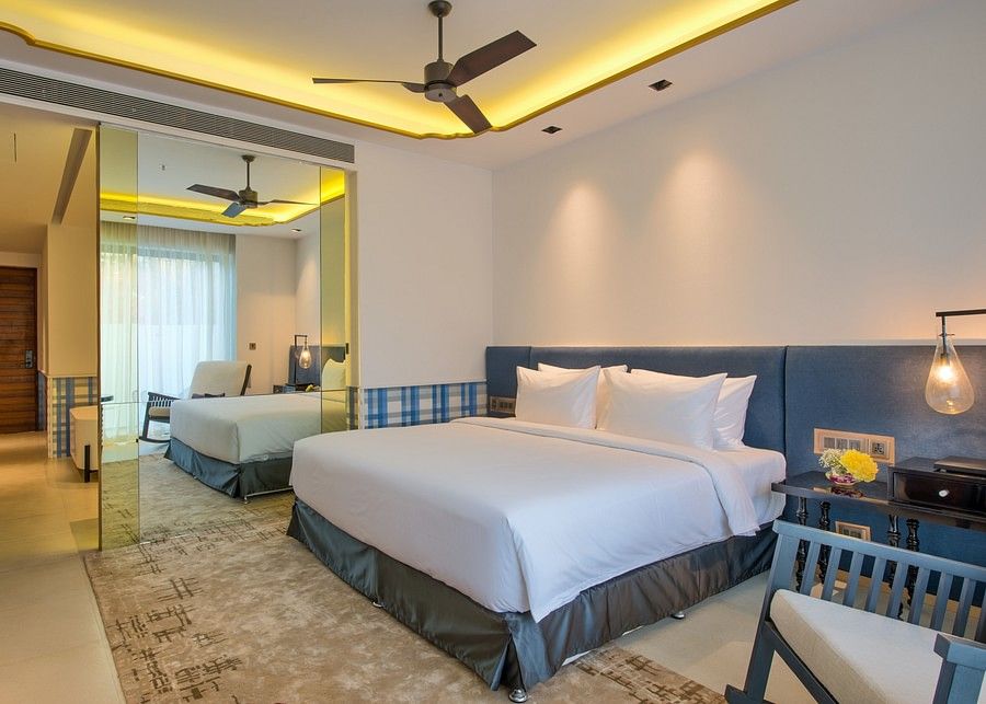 alt-text Well-lit bedroom with blue and white tones