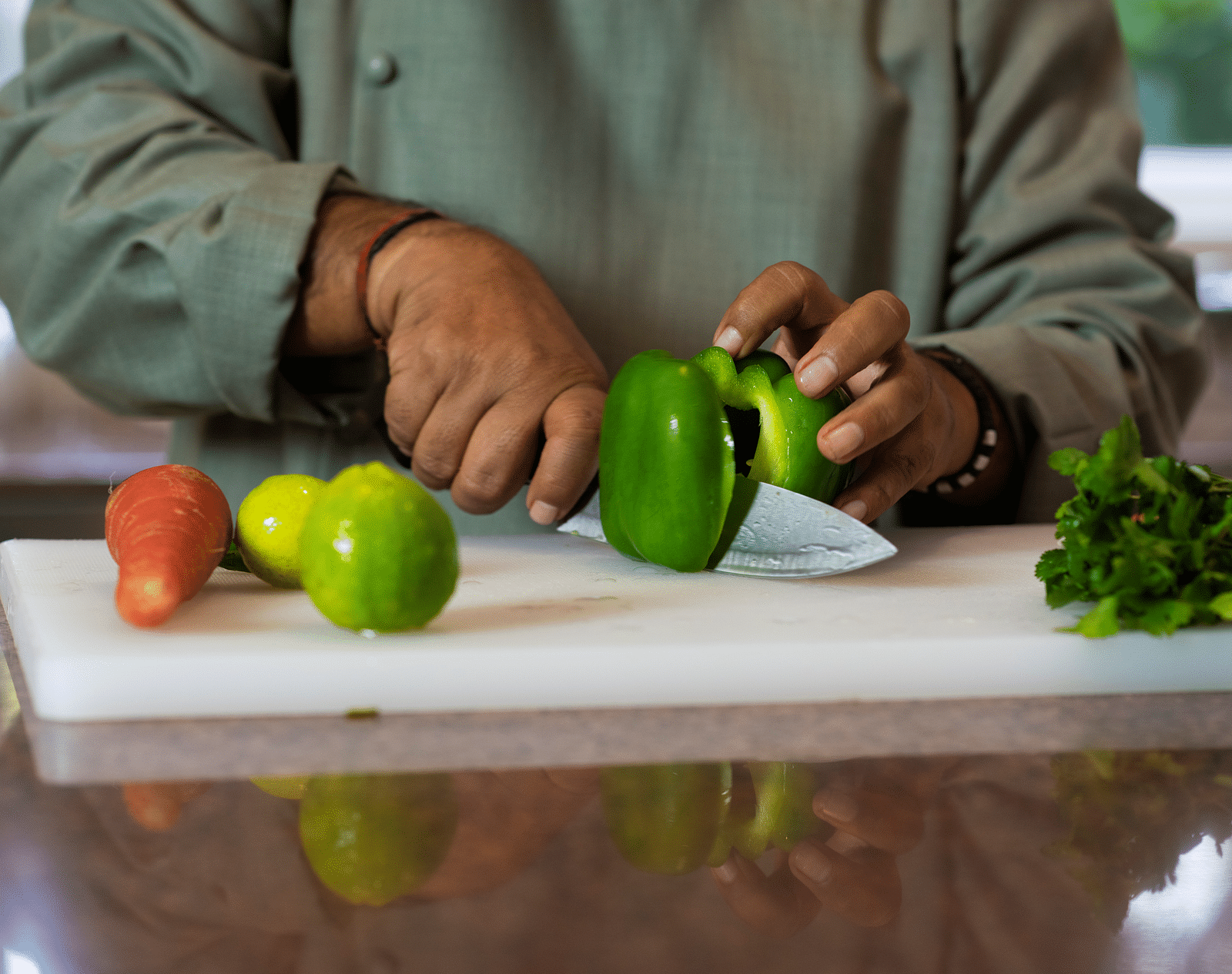 Image of a chef cutting vegetables on a chopping board.