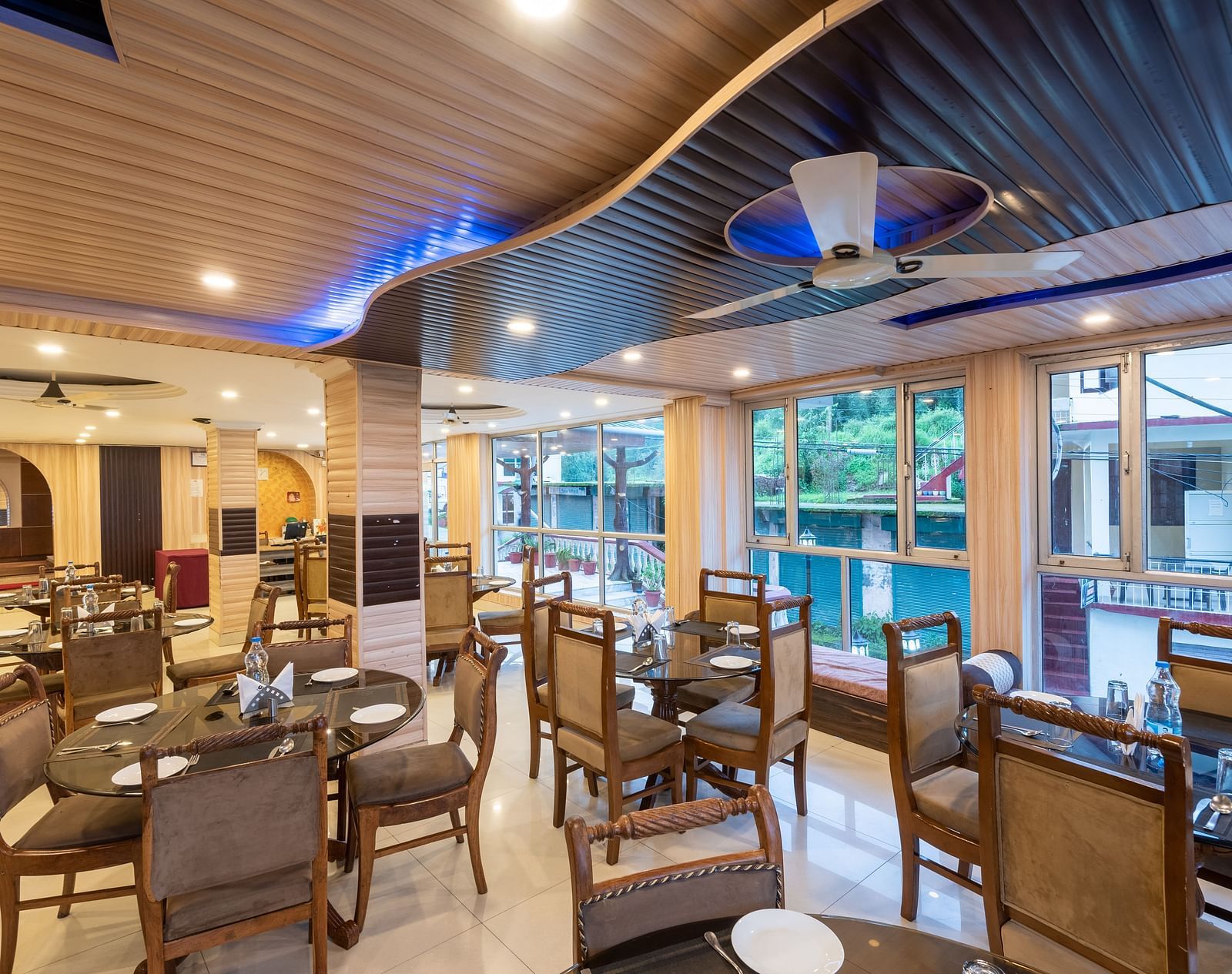 Image of the dining area featuring table and chairs | DLS Anupam Resort, Dharamshala