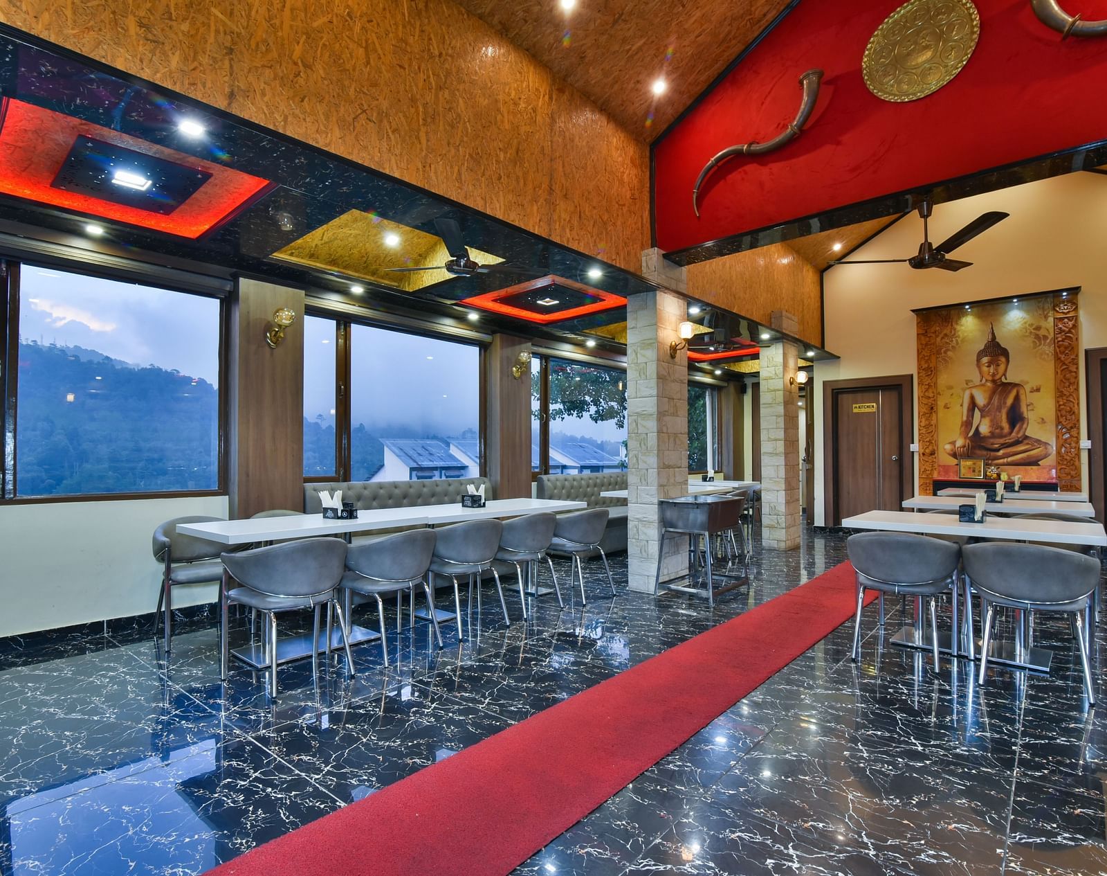 Restaurant at DLS Dalhousie Valley Resort with chairs, tables and serene views