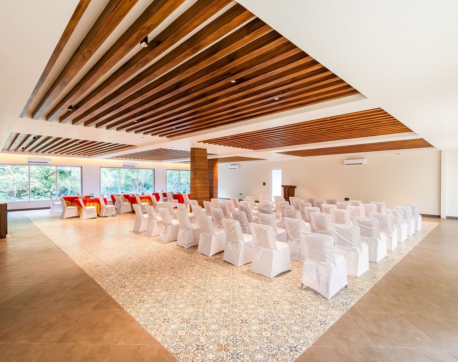 Overview of banquet hall at DLS Divine River Resort and Spa featuring  chairs table arranged in classroom setting and a stage