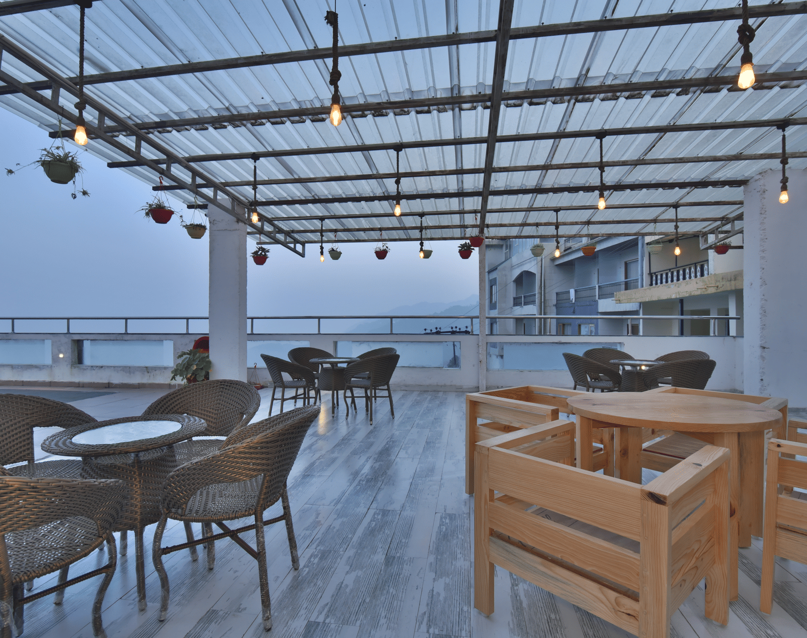 A view of the cafe with comfortable seating area at the rooftop at DLS Highland Resort and Spa, Mussoorie.