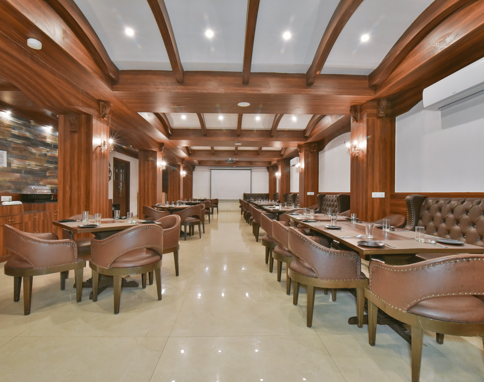 Dining seating with comfortable chairs around table at Ruttba at DLS Highland Resort and Spa, Mussoorie.