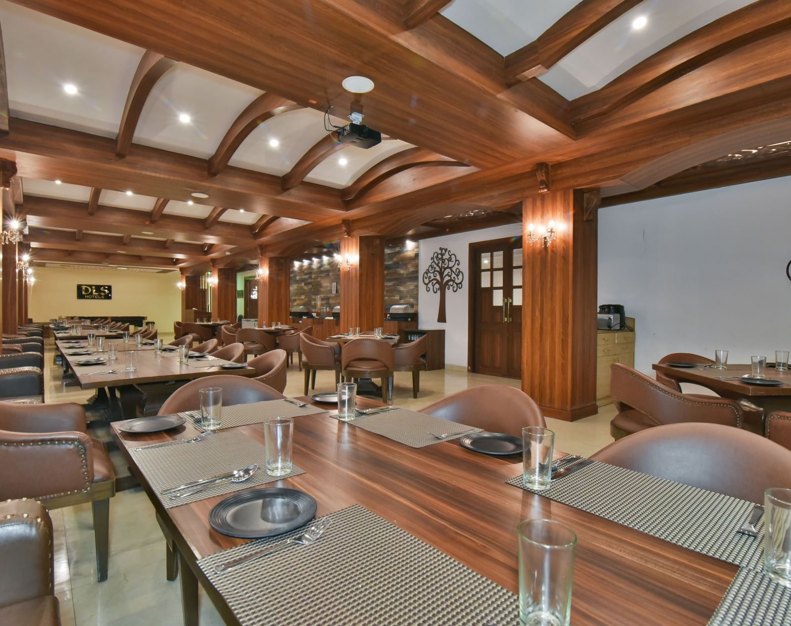 Dining seating with comfortable chairs around table at Ruttba at DLS Highland Resort and Spa, Mussoorie.