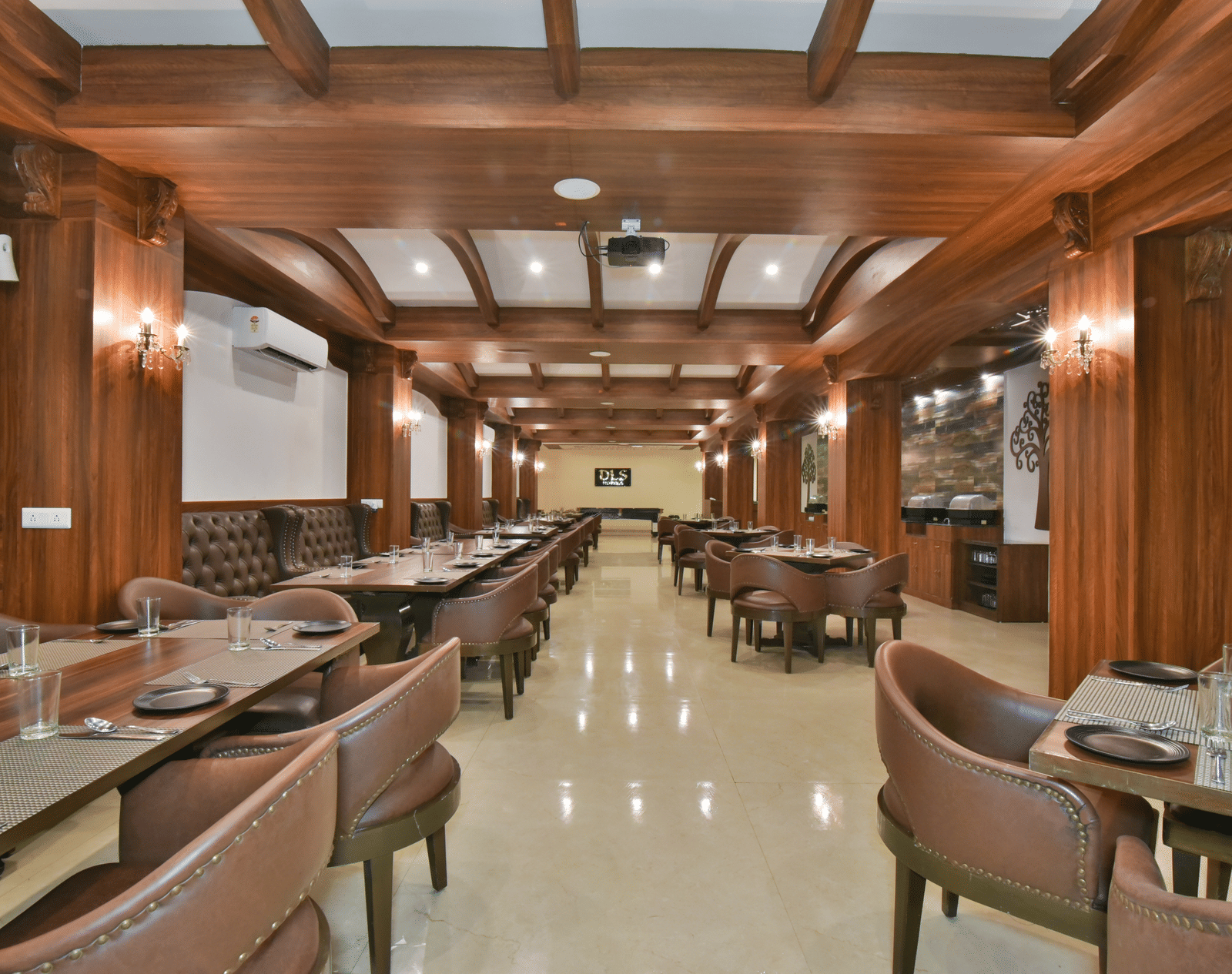 Dining seating with comfortable chairs around table at Ruttba at DLS Highland Resort and Spa, Mussoorie.
