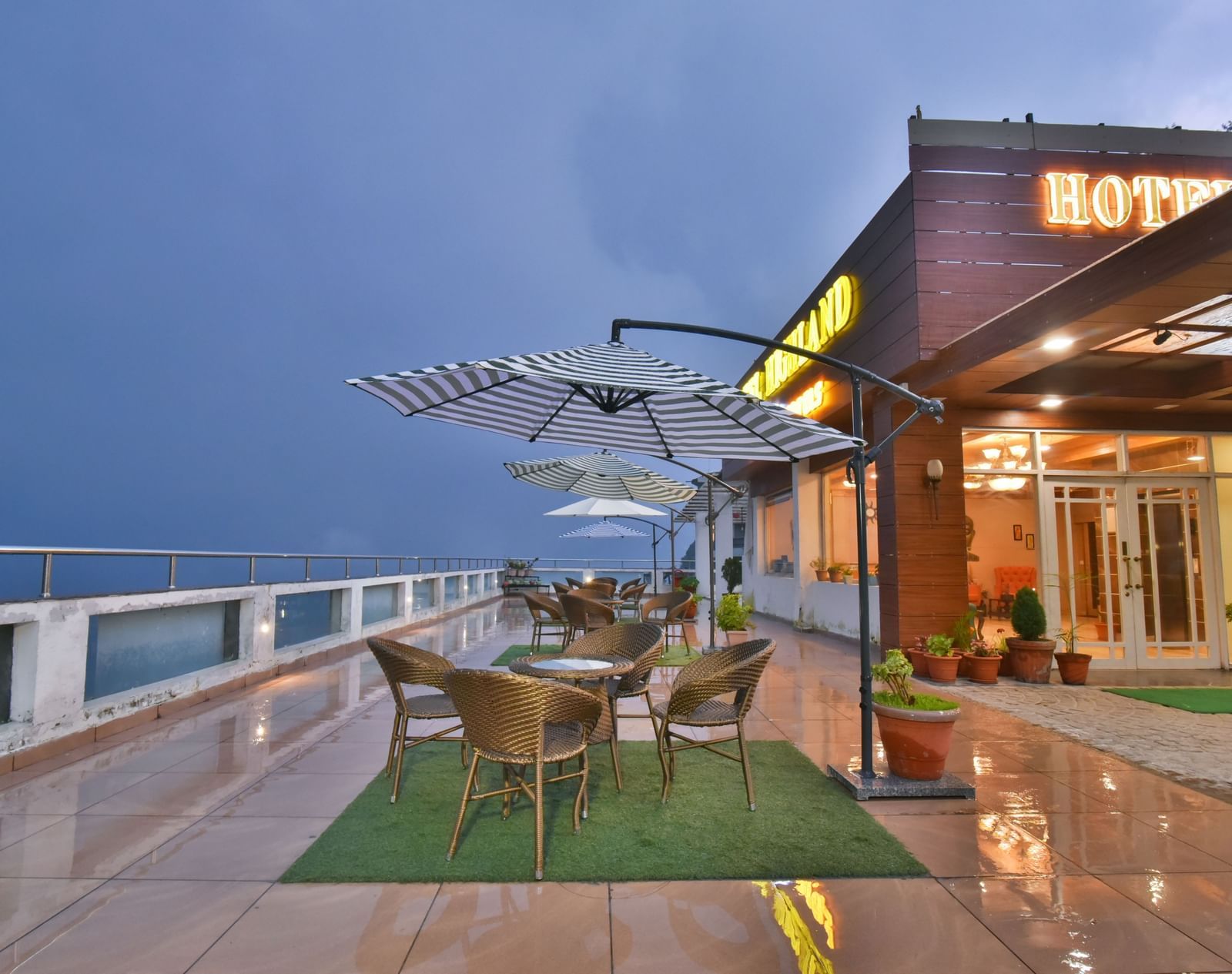 View of the terrace at DLS Highland Resort and Spa, Mussoorie with chairs around tables.