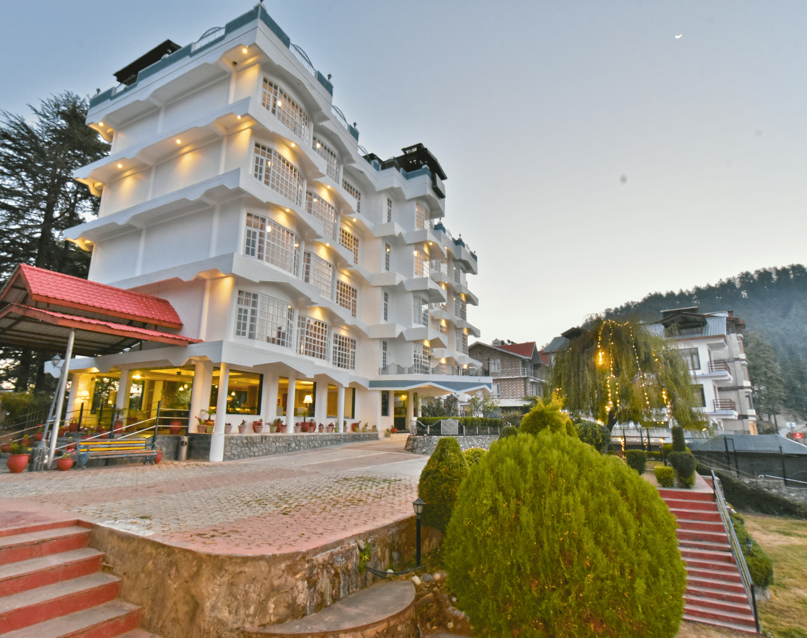 Side view of the facade of DLS Hillcrest Resort in Mashobra, Shimla, showcasing the architecture and scenic surroundings.