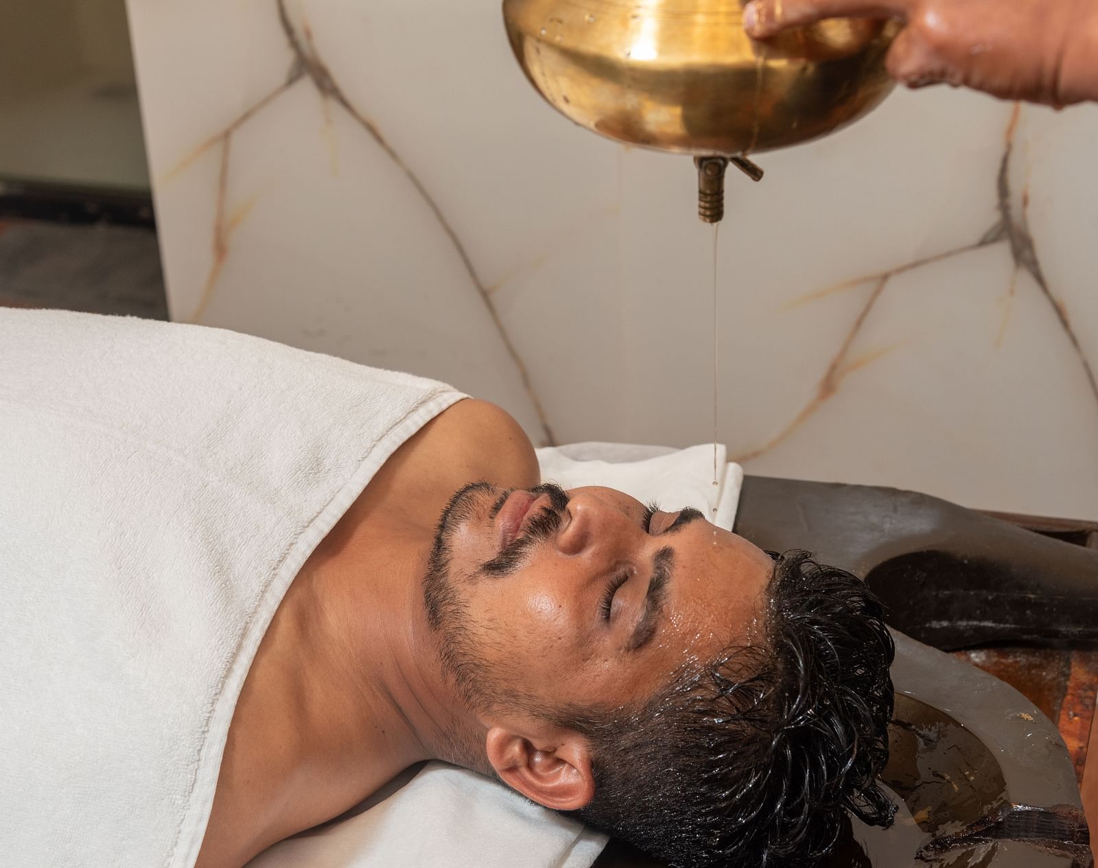 Shirodhara therapy in progress at Regenta Inn DLS, Rishikesh.
