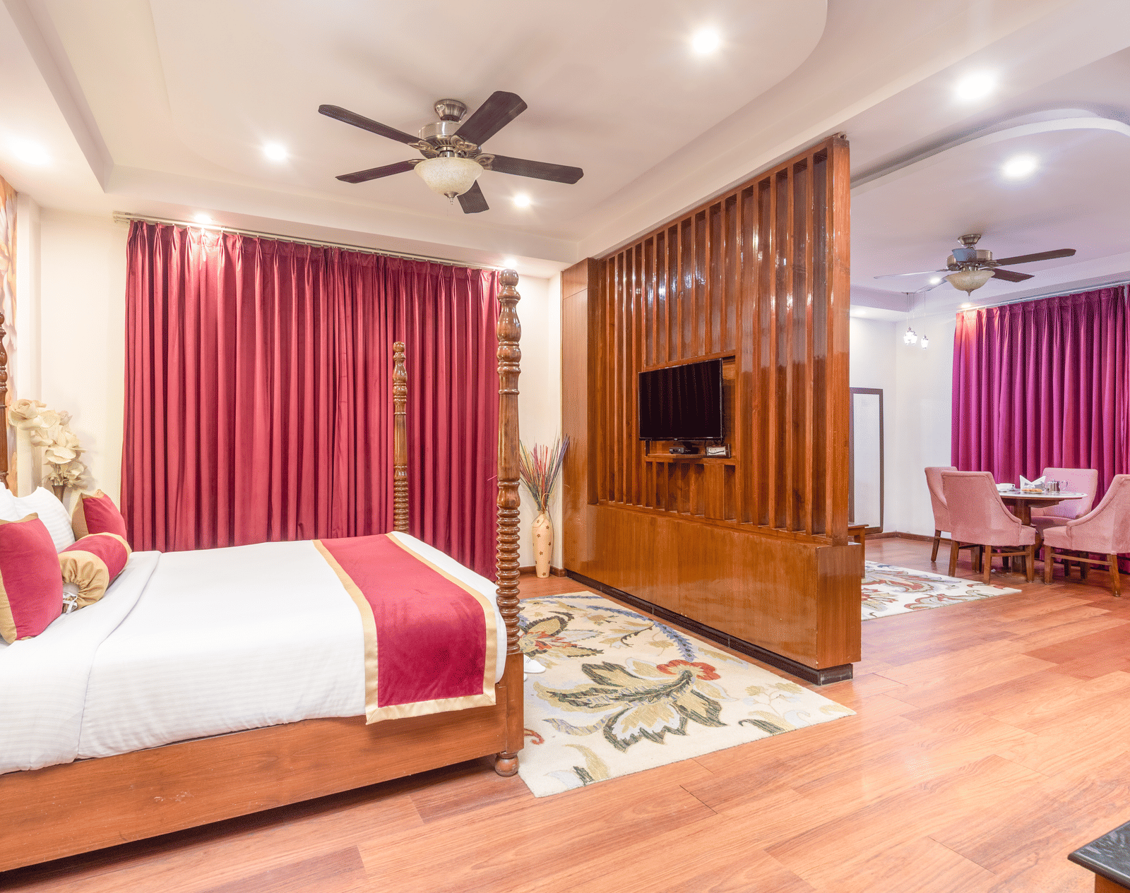 Double bed suite with pink curtains at DLS Hotels On The Ganges.