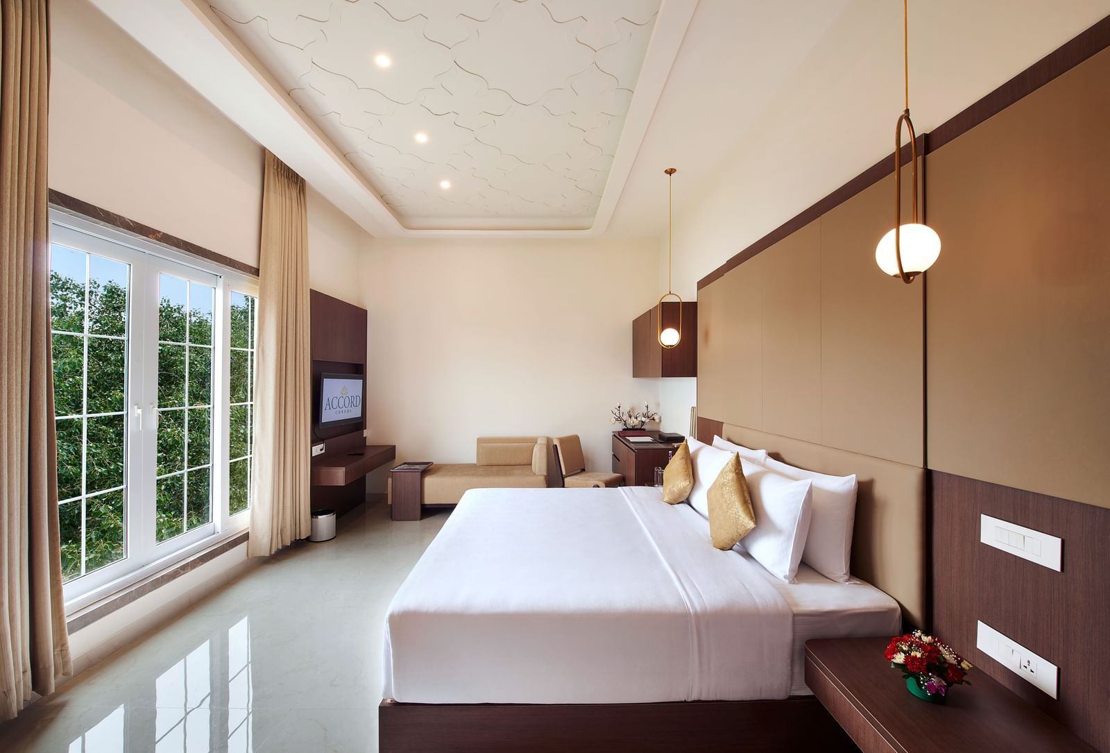 A hotel room with a bed placed in front of giant french windows - Accord Chrome Airport Hotel
