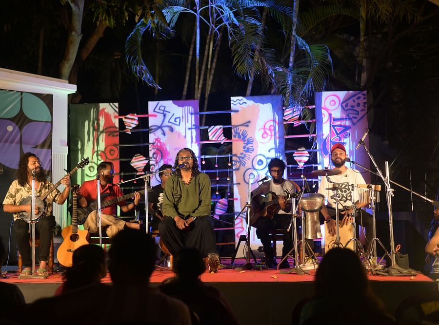 Event space at Rangamati Garden Resort featuring few artists singing at the stage surrounded by bright lighting.