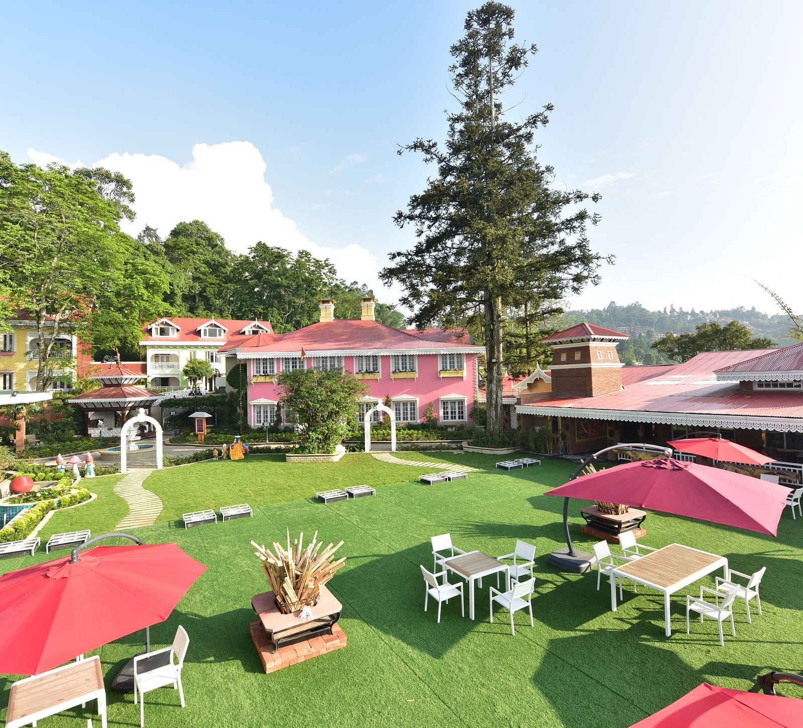 a panoramic view of the seating arrangement at the lawn - Mayfair Himalayan Spa Resort Kalimpong 1