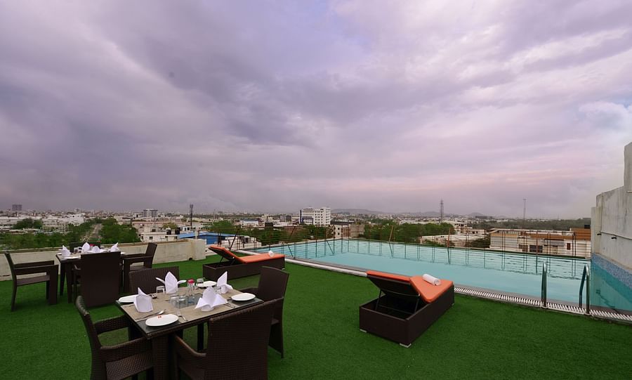 Rooftop Swimming pool with lounge chairs and a seating arrangement