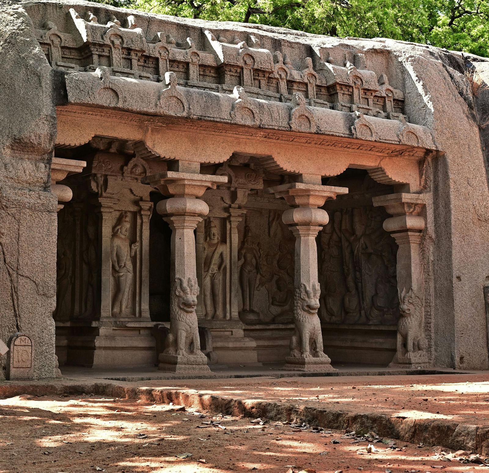 Exterior view of intricately carved rock building.