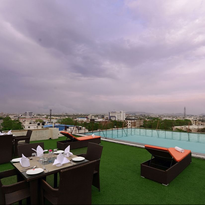 Rooftop Swimming pool with lounge chairs and a seating arrangement