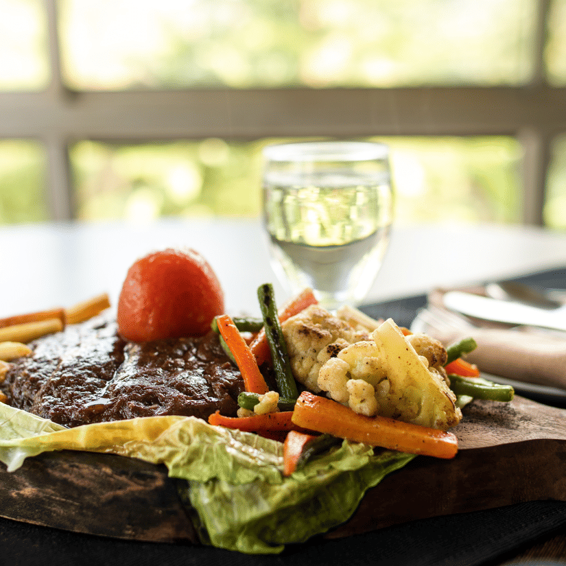 Food at rhe restaurant with a plate containing food, and a glass beside at Polo Hotels, Tura