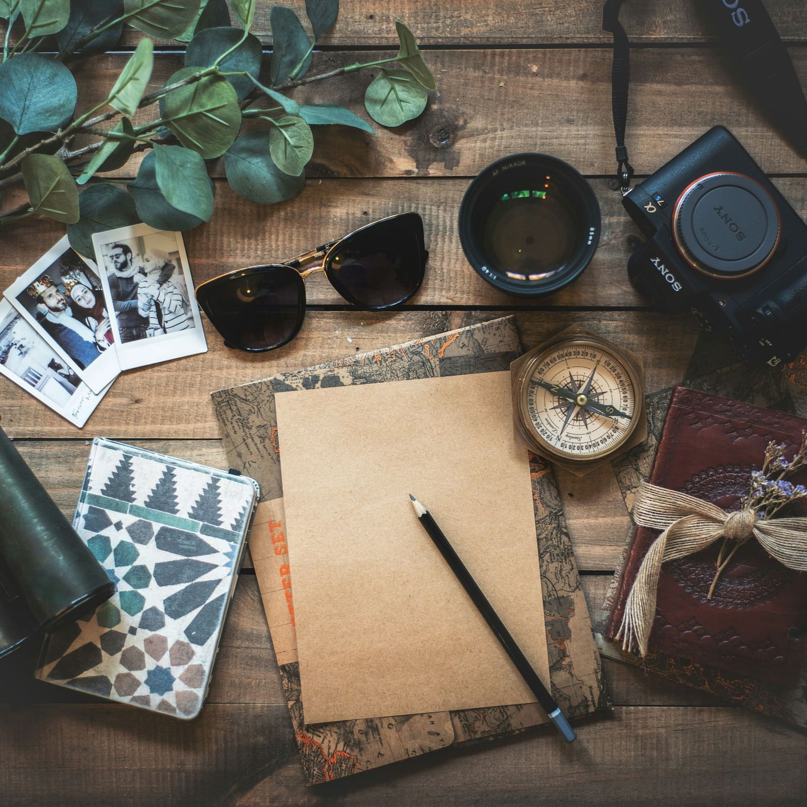 Image a table with a camera and other accessories on it.
