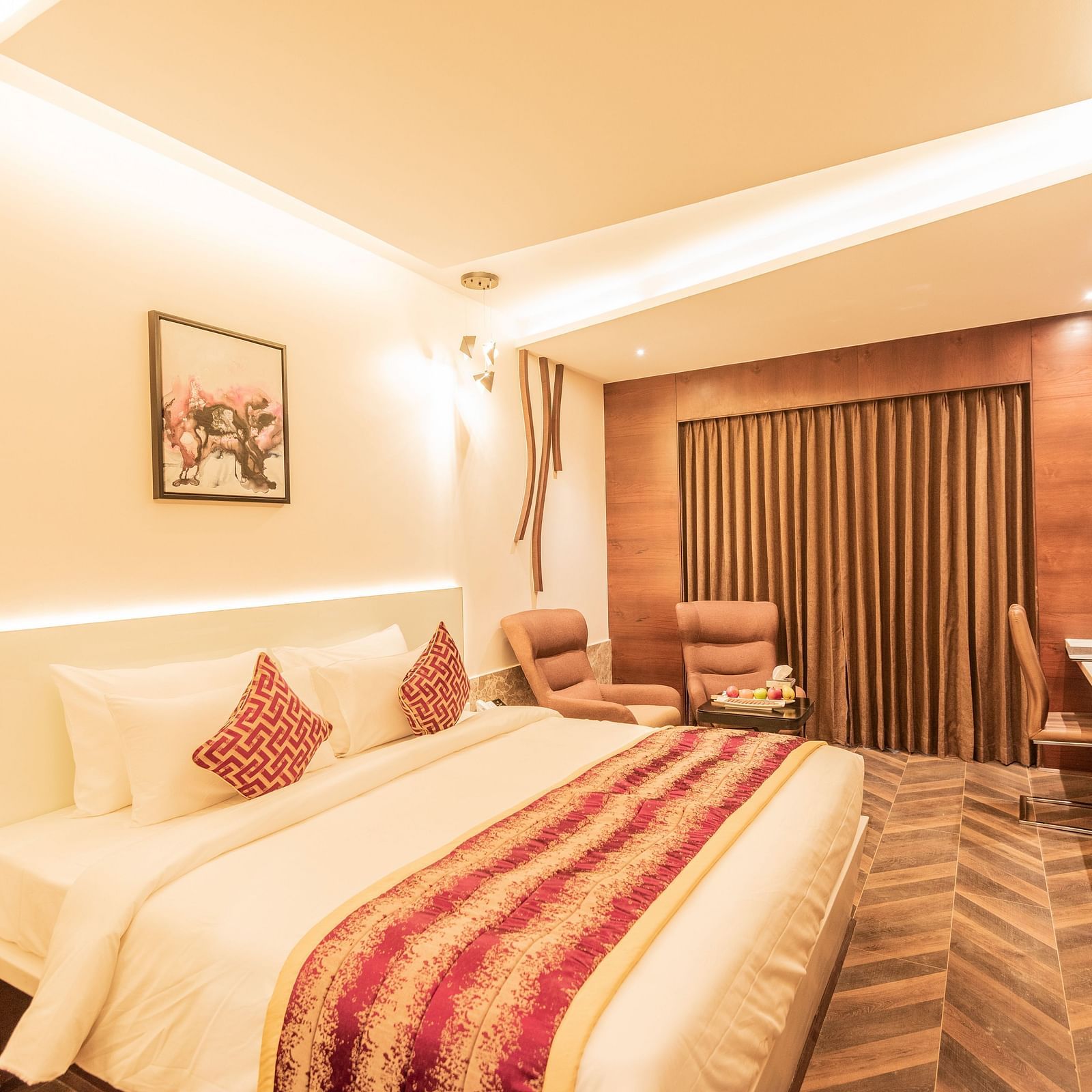 a comfy bed at Club Room featuring a red and yellow blanket and pillow at Hotel Park Elanza, Coimbatore