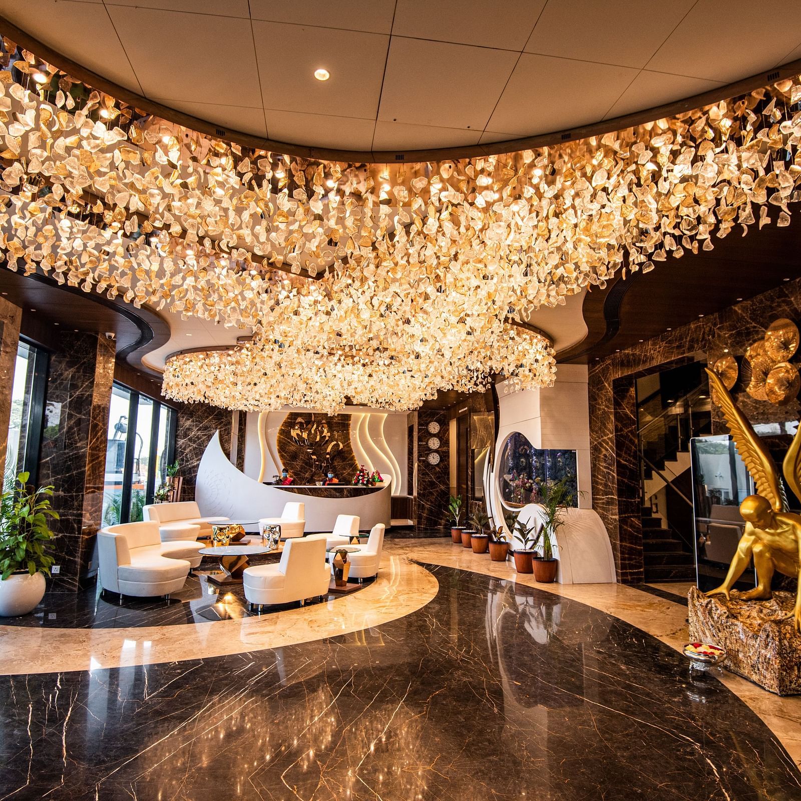 lobby of Hotel Park Elanza, Coimbatore decked with bright lights and plush seating arrangements