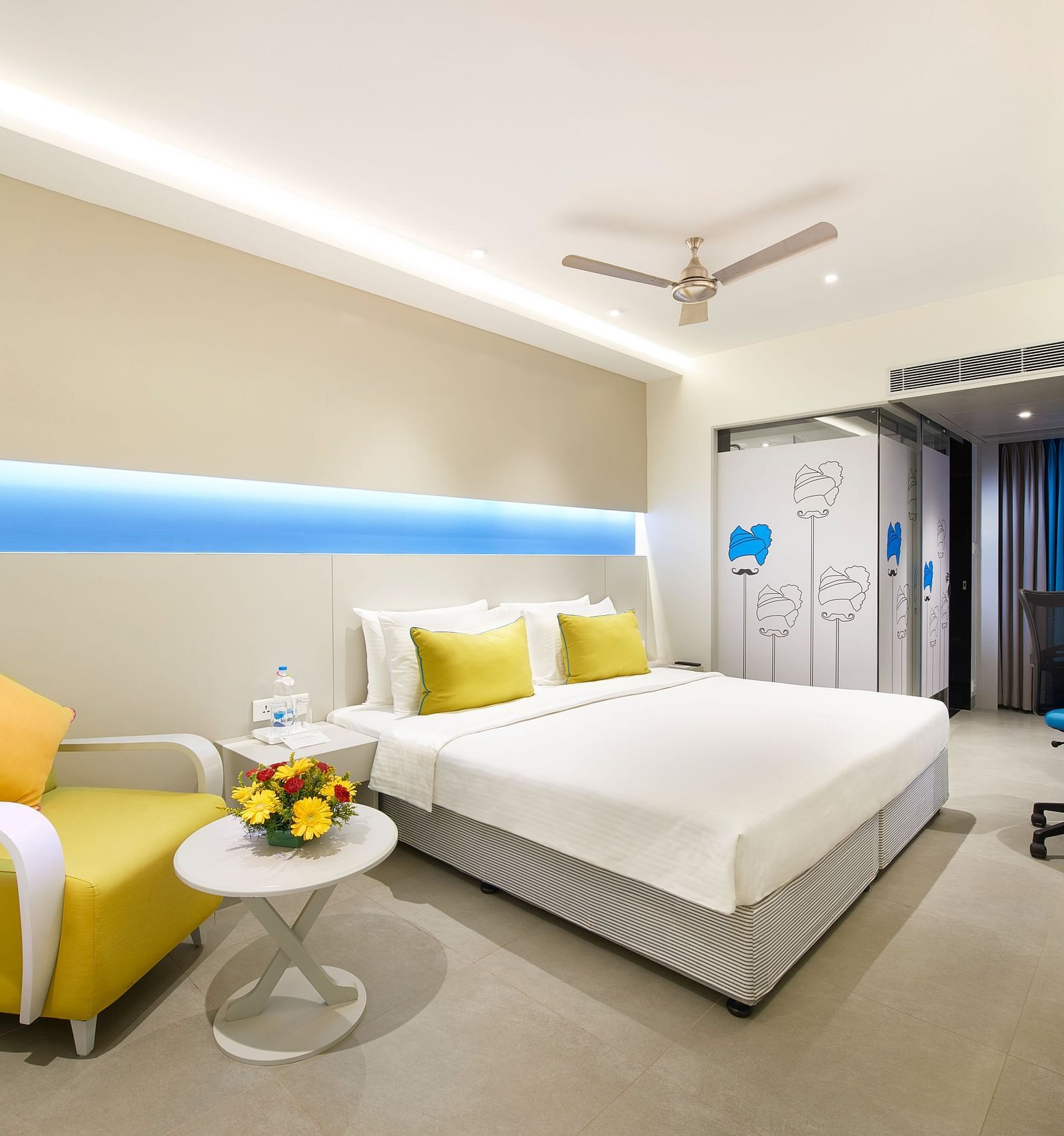 side view of a bedroom with a wall painting at  Zibe Salem by GRT Hotels