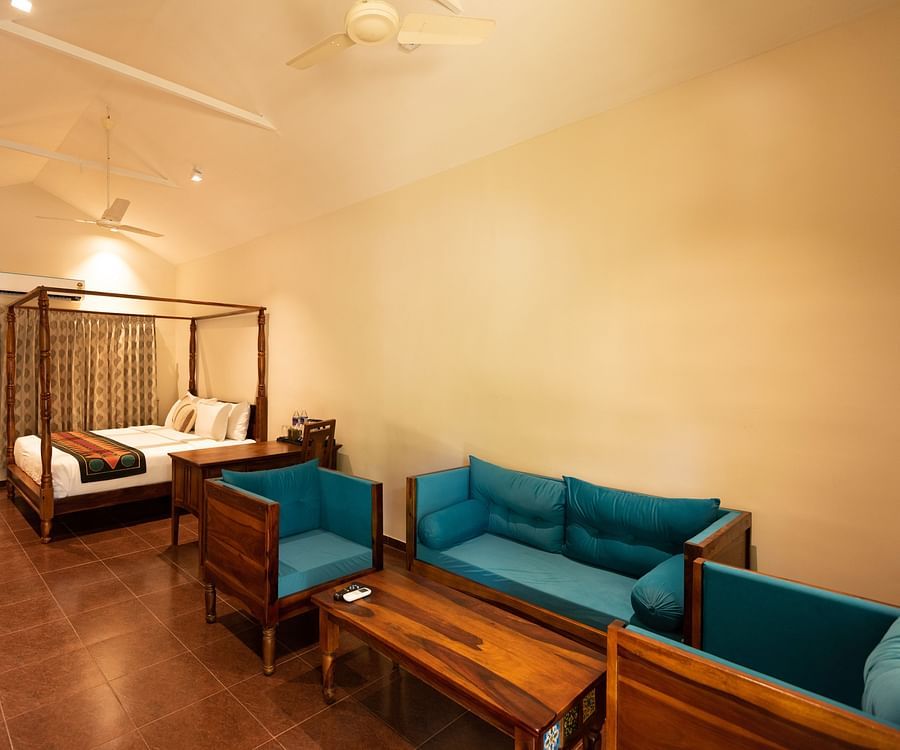 another view of sofas and a double bed inside Suite Room at Ibex River Resort, Pollachi