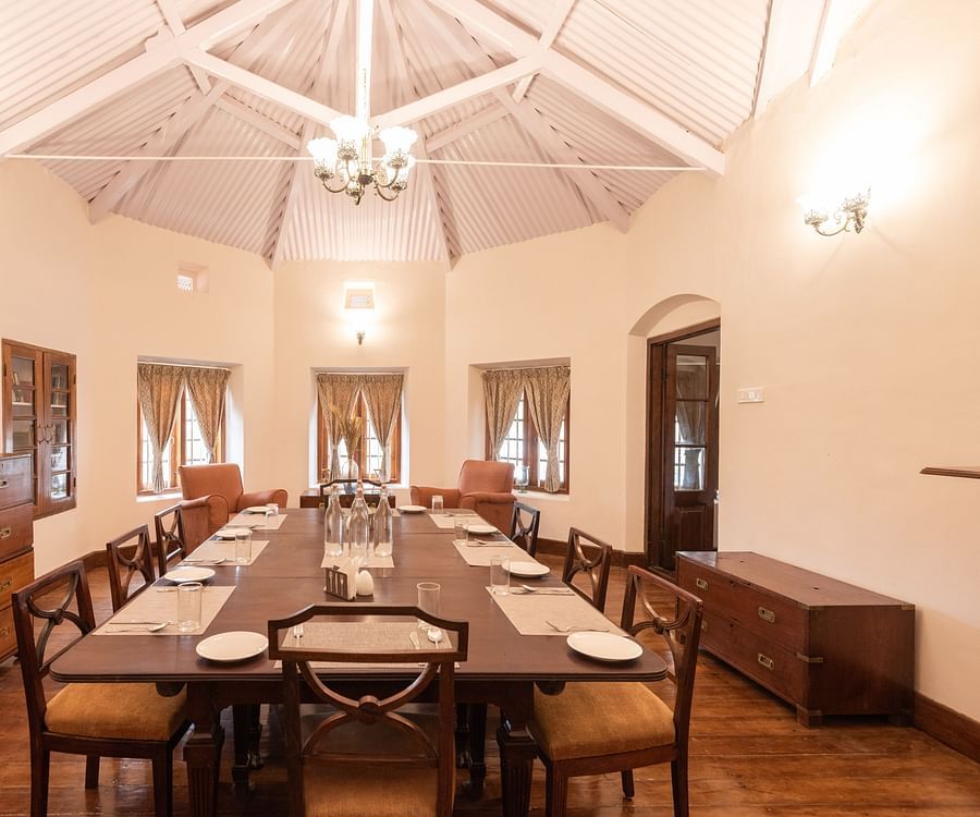 The interiors of the dining hall with a long dining table and rounded walls - Ibex Stays & Trails, Coonoor (Leewood).