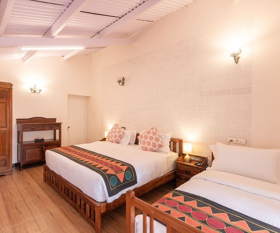 The interiors of the Oxford bedroom with king size bed, wooden floors and white walls - Ibex Stays & Trails, Coonoor (Leewood).