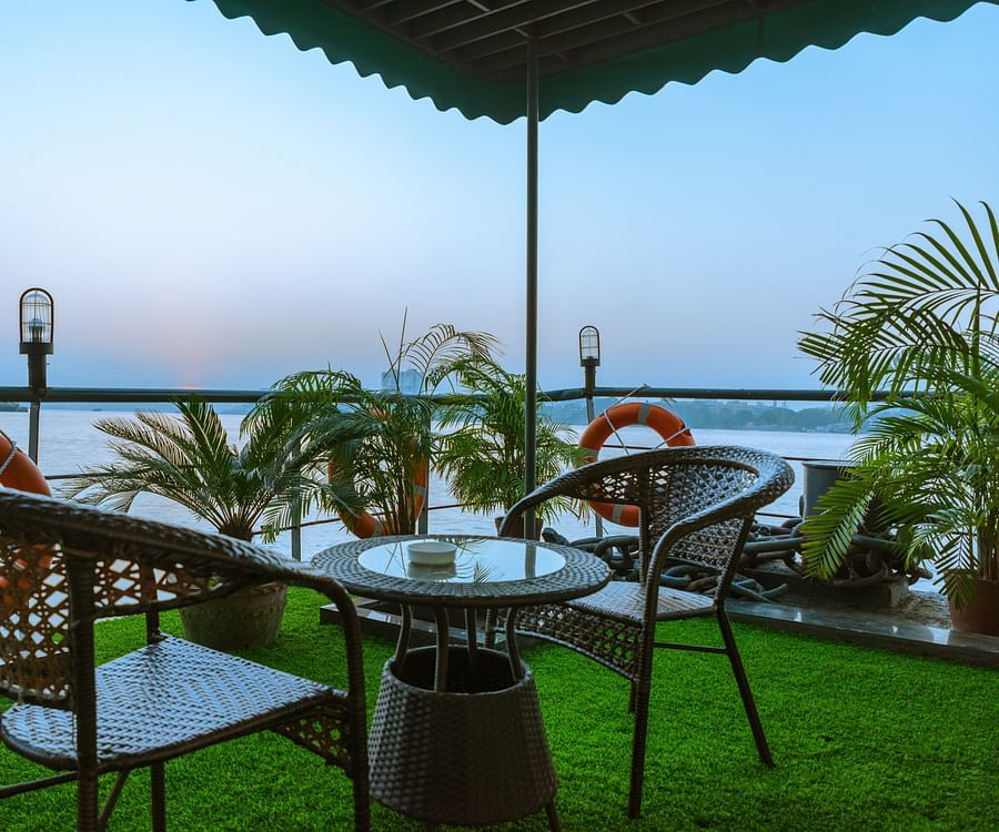a seat for two on the outside deck overlooking river hooghly - polo floatel kolkata
