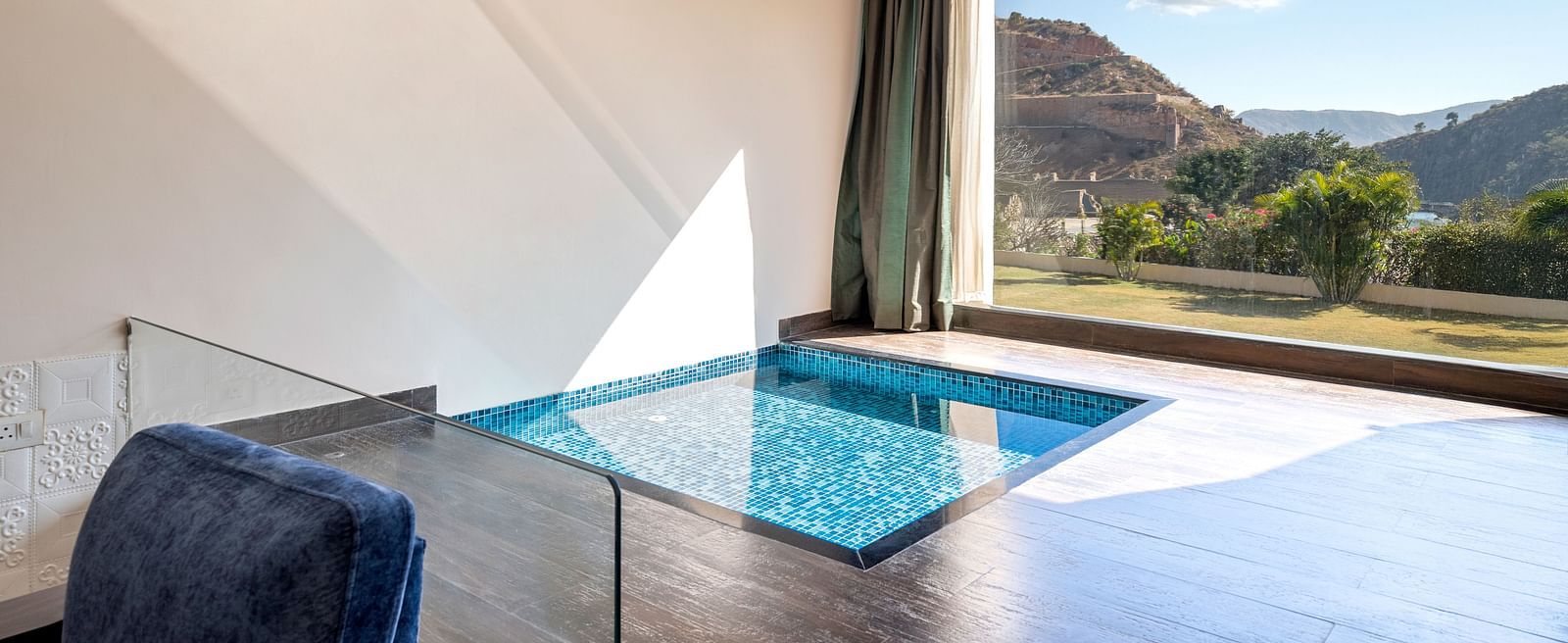 A private plunge pool on a balcony with mountains visible through open wall - Via Lakhela Resort & Spa