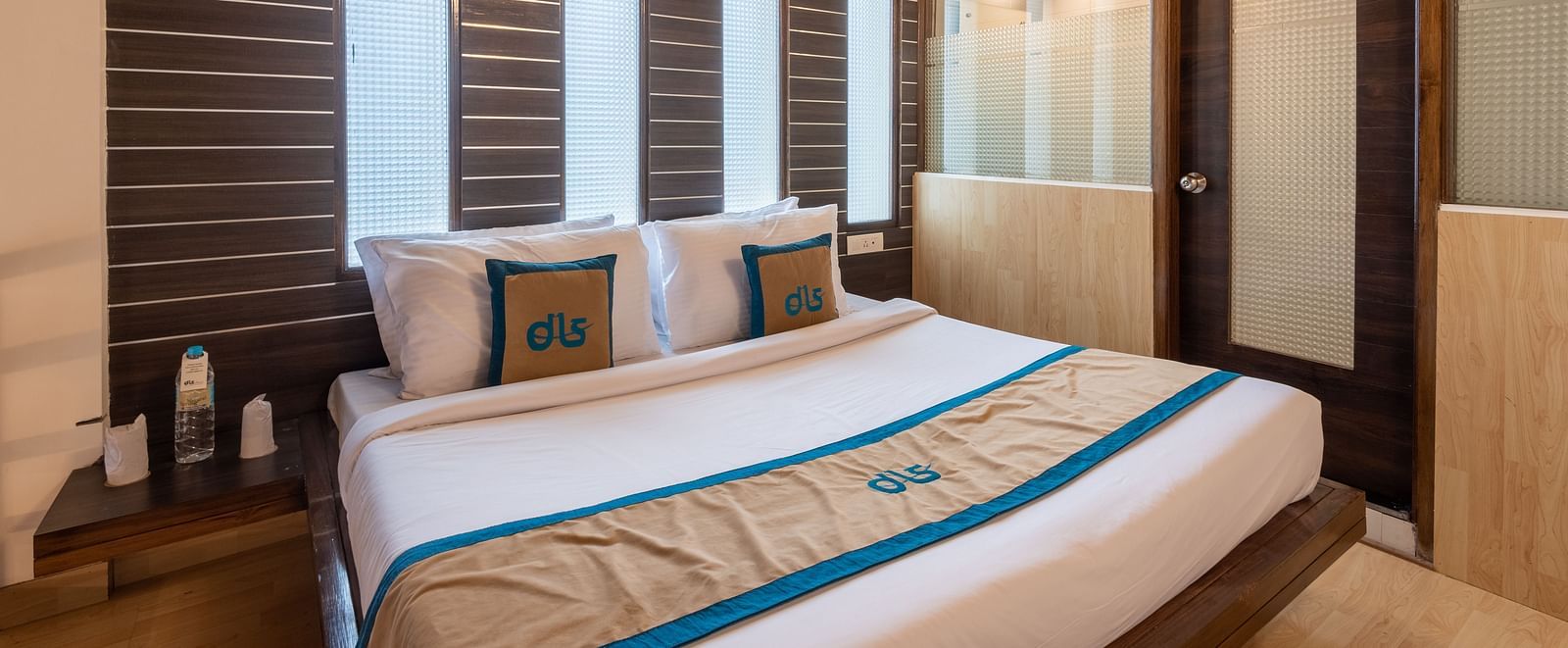 A bedroom with a wooden ceiling, king size bed, modern design, large windows with blinds, and a glass partition - DLS Meghavan Resort, Dharamshala