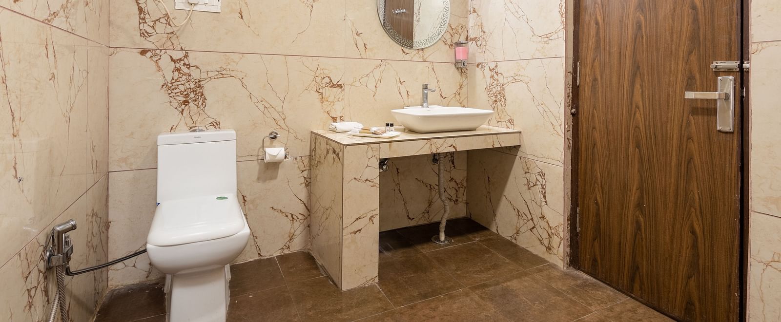 Image of a washroom featuring a basin and a commode | DLS Anupam Resort, Dharamshala
