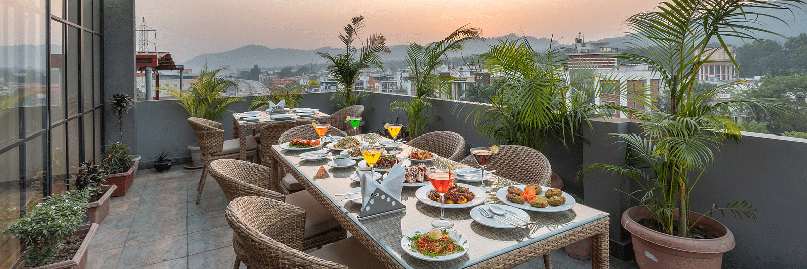 The roof top dining at DLS Hotel Arihant, Haridwar with chairs and tables overlooking the view