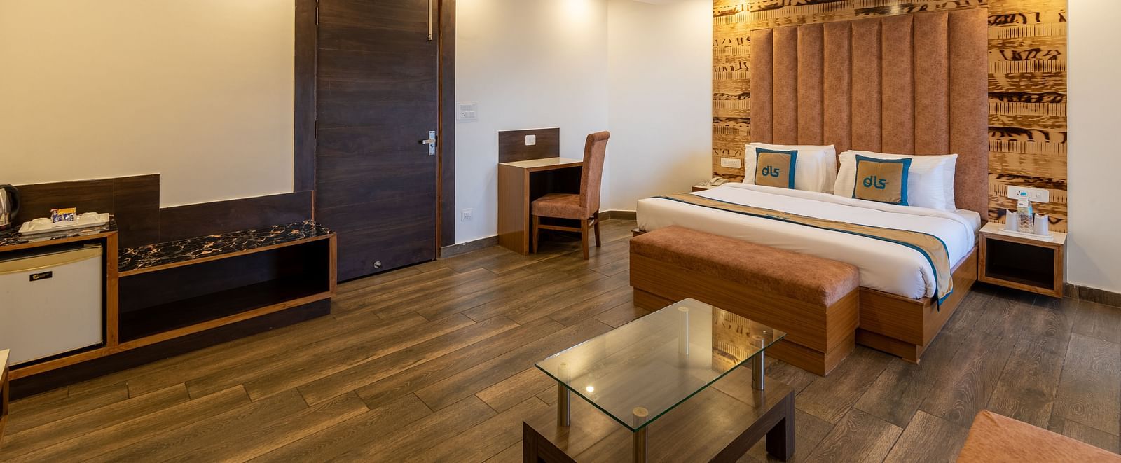 A modern premium room with a comfortable bed, work desk, and sleek wooden interiors for a relaxing stay - DLS Meghavan Resort, Dharamshala