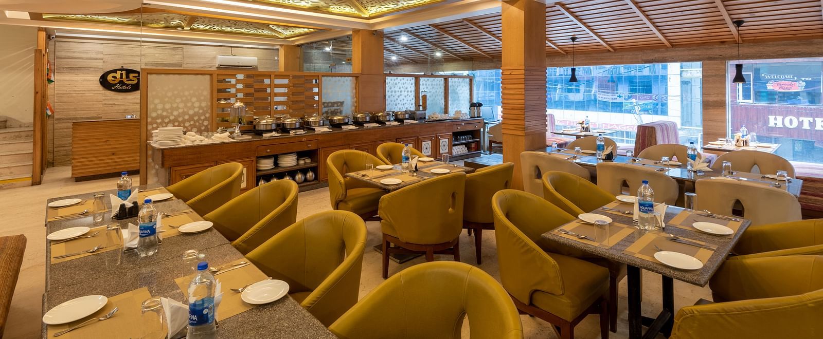 Restaurant at DLS Spring Valley Resort Dharamshala  with seating arrangement and ambient lighting 