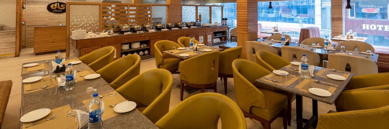 Restaurant at DLS Spring Valley Resort Dharamshala  with seating arrangement and ambient lighting 