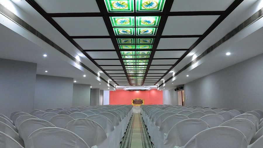 Back view of banquet hall with multiple chairs arranged for meetings and celebrations - Jayaram Hotel, Pondicherry