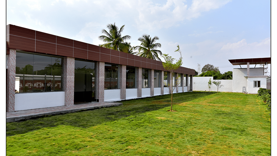 an image of a well-maintaied green lawn with buildings around captured during the day - Royal Lotus View Resotel
