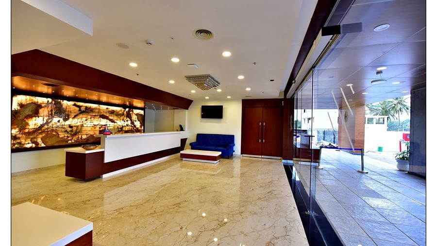 different angles of the reception area with blue coloured couch in a corner and well-lit surrounding - Royal Lotus View Resotel2
