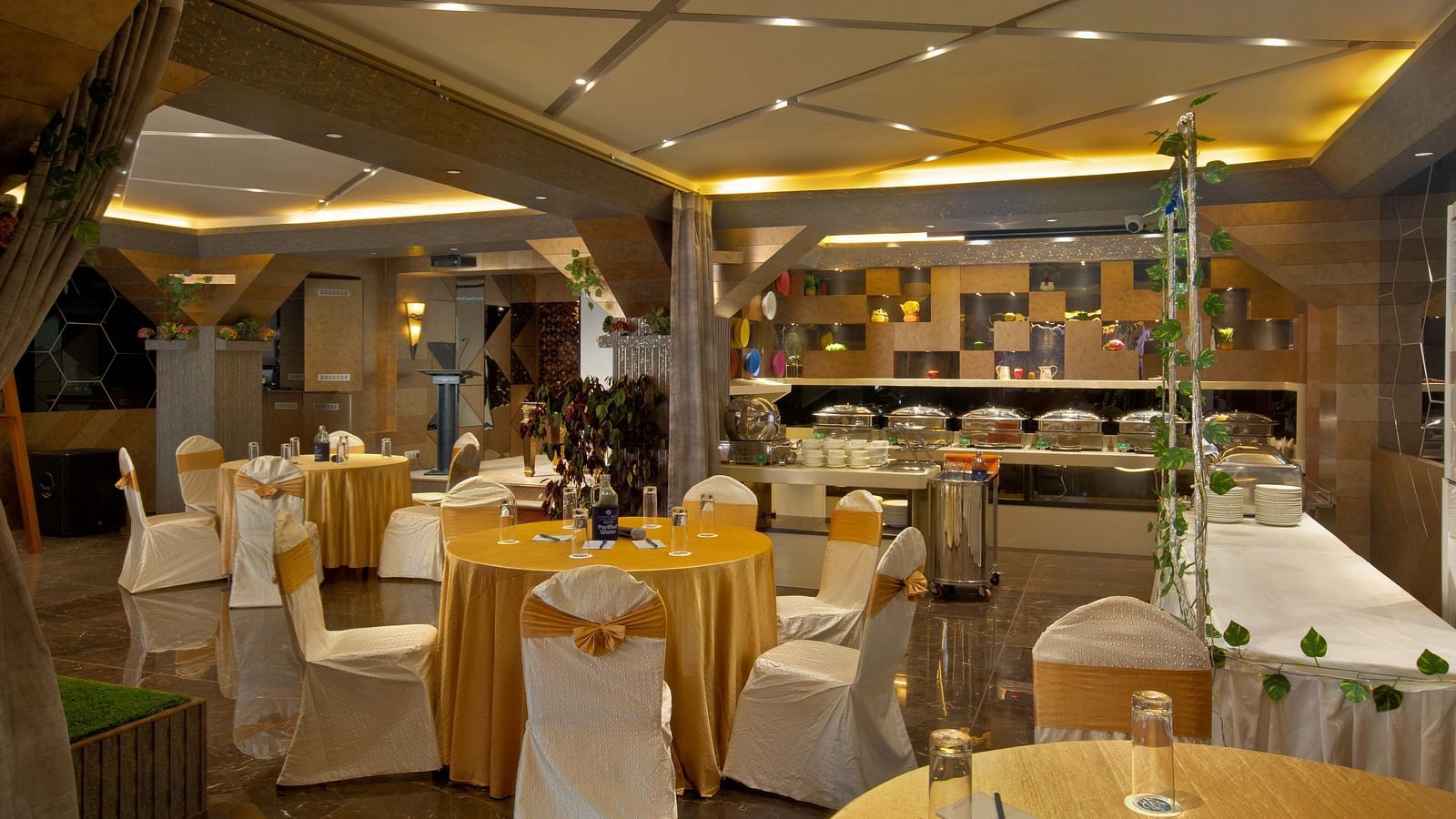 Image of tables and chairs arranged in circle at Mosaic Hall at Coral Reef Hotel and Spa in Port Blair