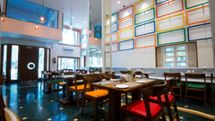 seatings arrangements inside the restaurant with plates kept on the table - VITS Sharanam, Thane