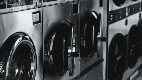washing machines and dryers stacked next to each other with the image in black and white
