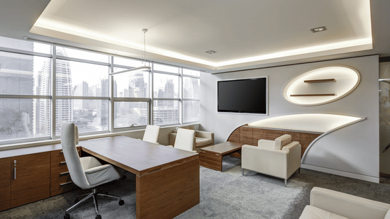 Executive office meeting area with desk, seating, and soft ambient lighting