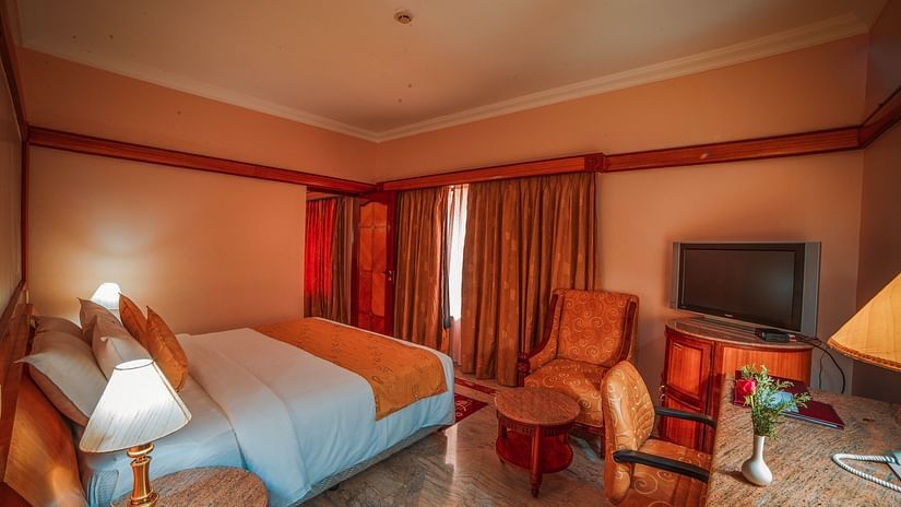 overview of a room with a double bed, side tables and lamps - Raj Park Hotel, Chennai