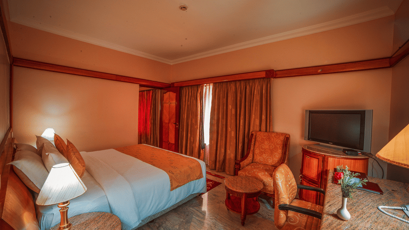 A double bed inside a bedroom at Superior Room at hotel Raj Park, Chennai