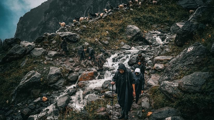 a group of trekkers climbing on a Hampta Pass trek with rocky terrain in view
