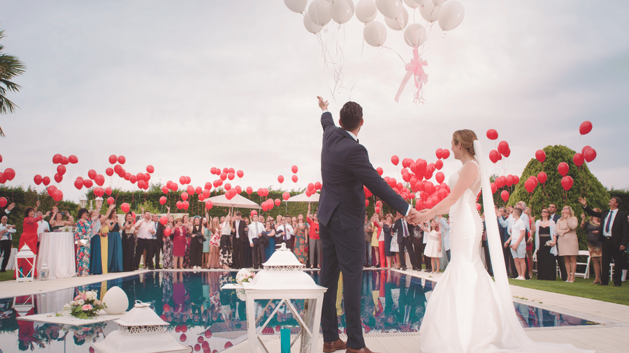 a couple on their wedding day with balloons flying
