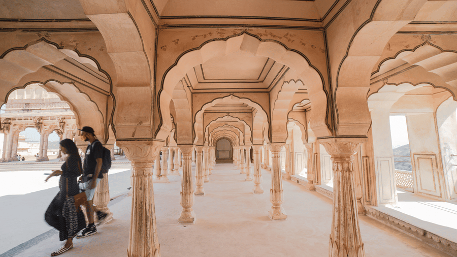 a couple roaming around an arch-shaped temple ground