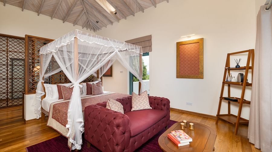 A tastefully designed bedroom with a canopy bed, a sitting corner, and warm ambient lighting - Executive Suite at Heavensa Villas and Suites by the Clarks, Galle