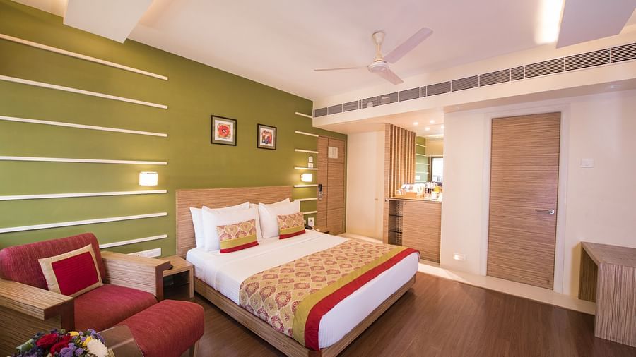 room with green interiors and wooden flooring - hotel bawa suites