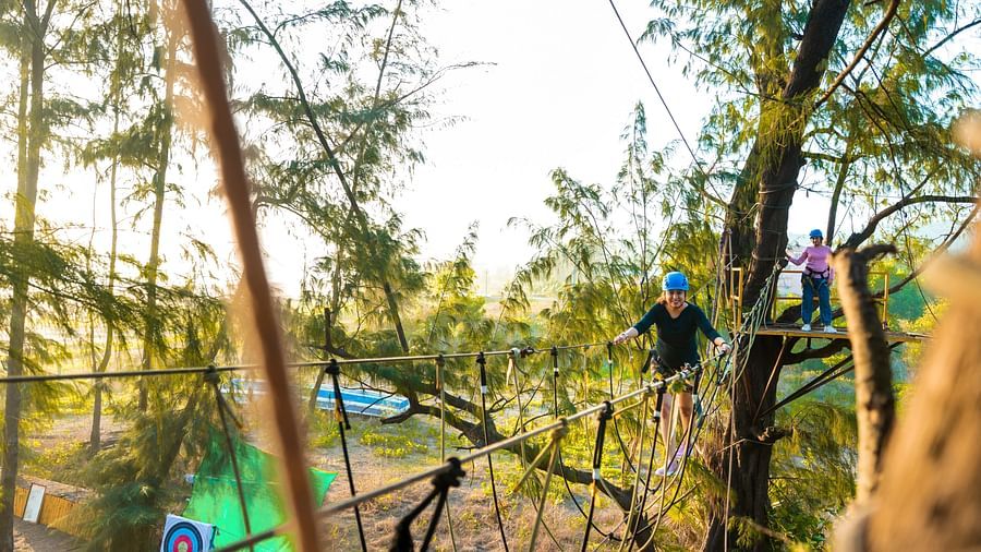A person walking on a tightrope bridge 4